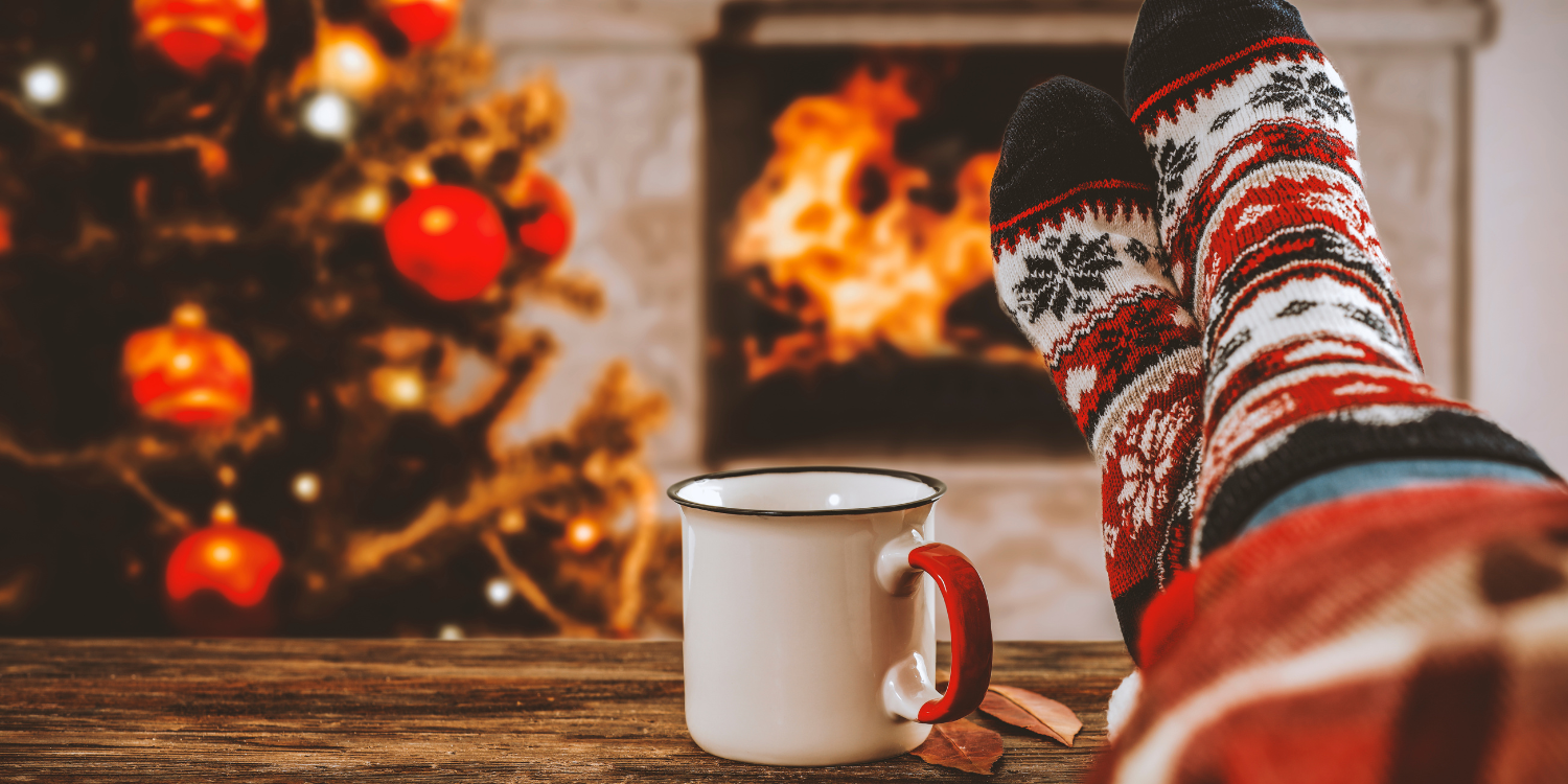 Women feet in front of wood burning fireplace at Christmas -